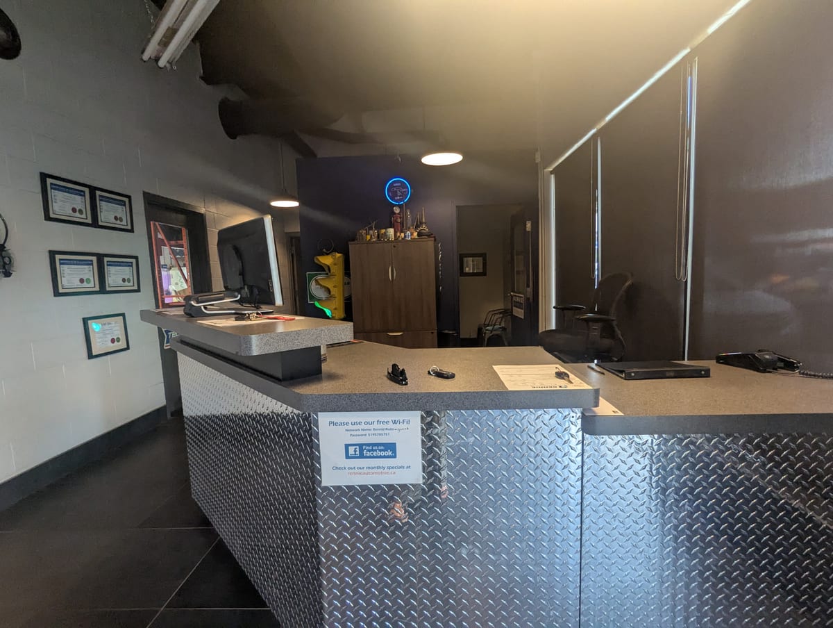 The Rennie Automotive service counter faced in diamond plate, framed certificates on the wall behind